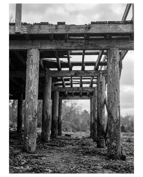 Weathered elevated wooden deck on aging support posts