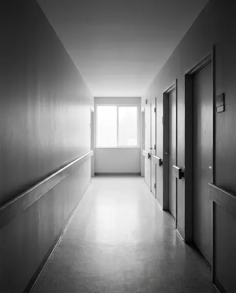Empty nursing home corridor with a continuous wall handrail