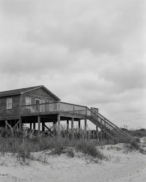 Coastal vacation rental beach house with an elevated deck and exterior stairs